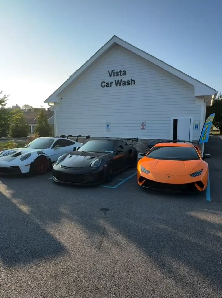 Vista Hand Wash facility with luxury vehicles including Porsche and Lamborghini showcasing premium car care services